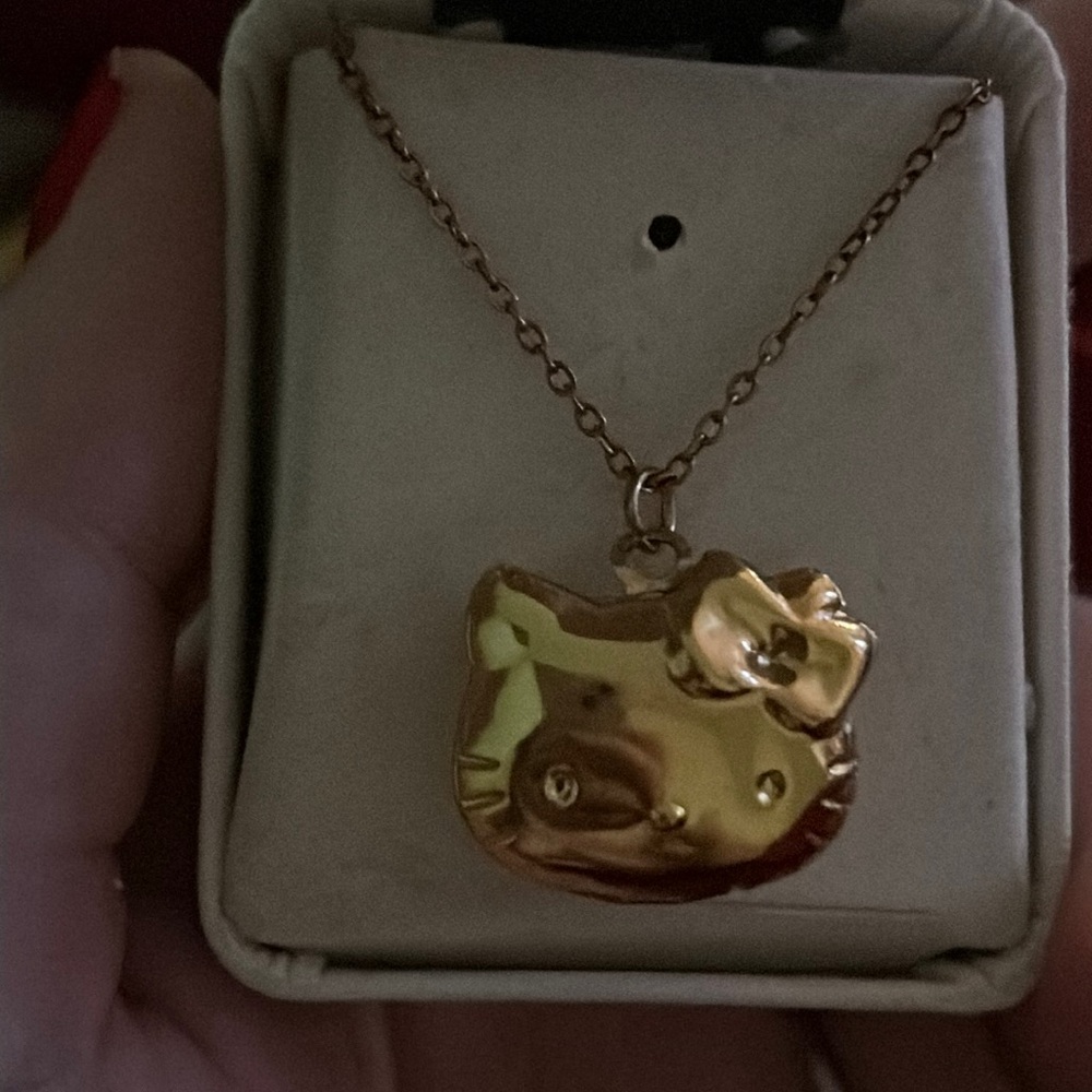 hello kitty pendant not real gold chain but real turquoise's inside